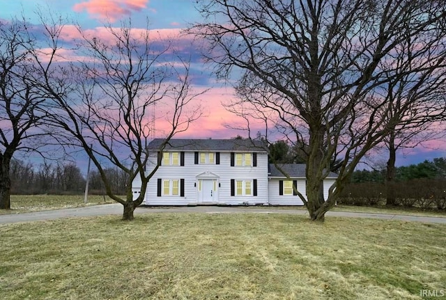 colonial-style house featuring a yard