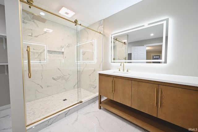 bathroom with vanity and a shower with shower door