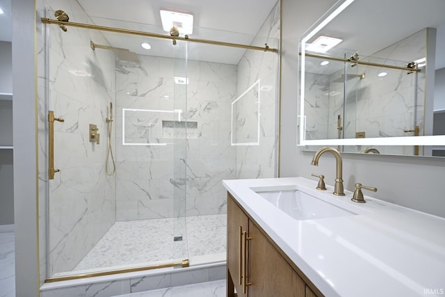 bathroom featuring vanity and an enclosed shower