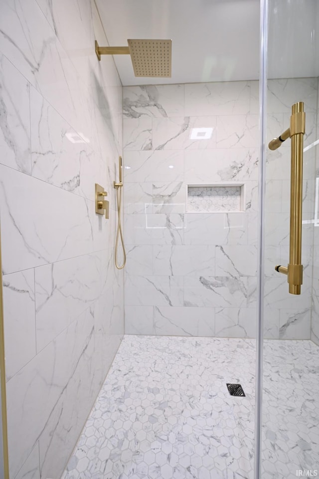 bathroom with tiled shower