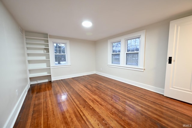 empty room featuring dark wood-type flooring