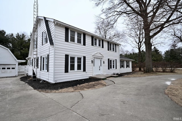 colonial house with an outbuilding and a garage