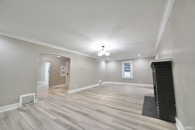 unfurnished living room featuring ornamental molding, an inviting chandelier, and light hardwood / wood-style floors