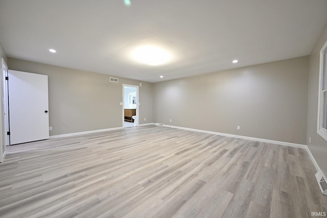 spare room with light hardwood / wood-style flooring