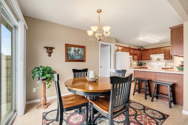 dining area featuring an inviting chandelier and light tile patterned floors