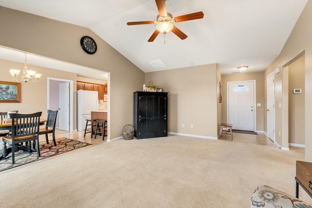 carpeted living room featuring lofted ceiling and ceiling fan with notable chandelier