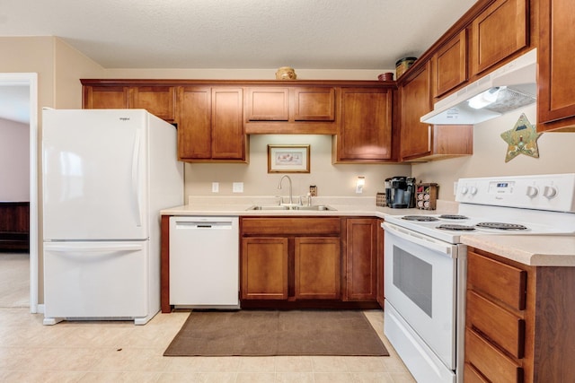 kitchen with white appliances, sink, and a textured ceiling