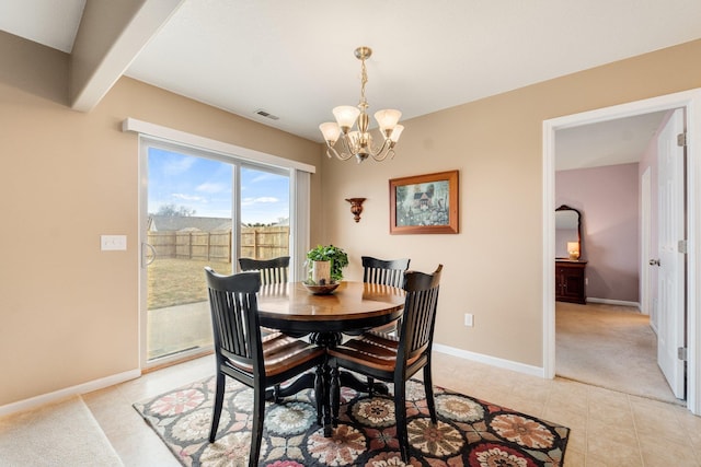 carpeted dining space featuring an inviting chandelier