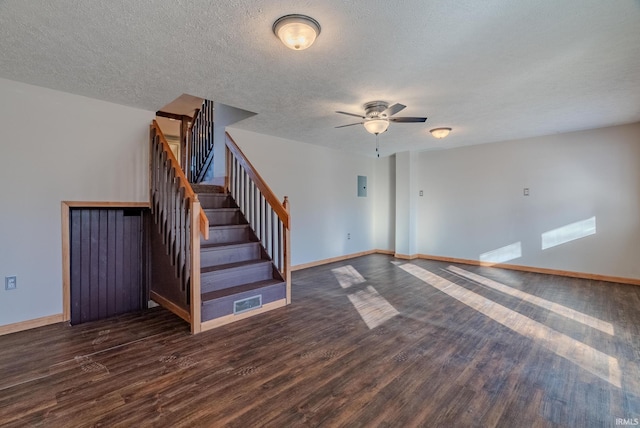 interior space featuring dark hardwood / wood-style flooring, ceiling fan, and a textured ceiling