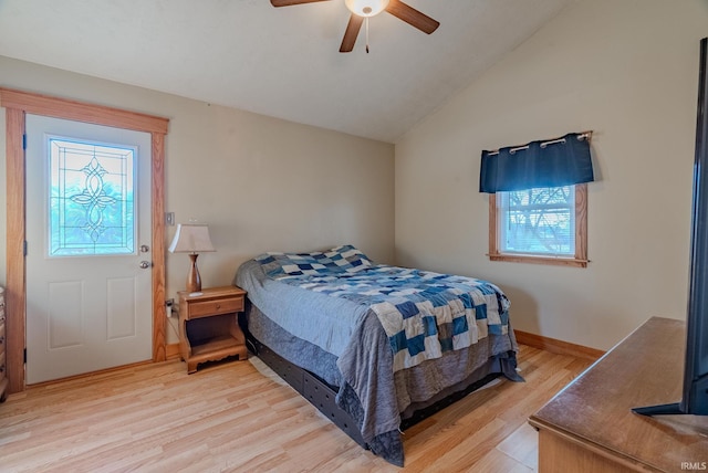 bedroom with ceiling fan, vaulted ceiling, and light wood-type flooring