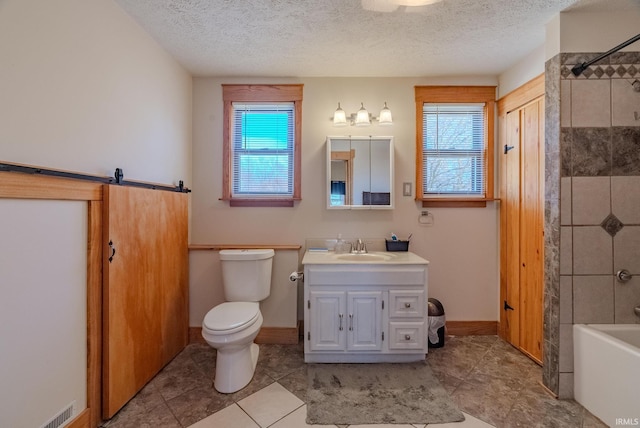 full bathroom featuring plenty of natural light, vanity, and a textured ceiling