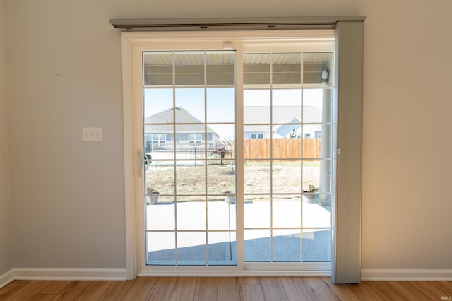 doorway featuring a wealth of natural light and light hardwood / wood-style flooring