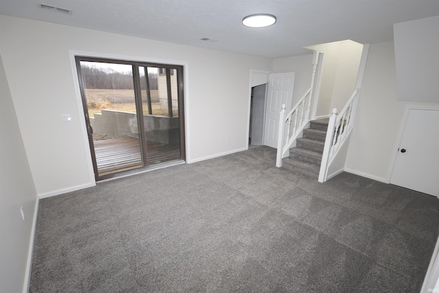 unfurnished living room with dark colored carpet