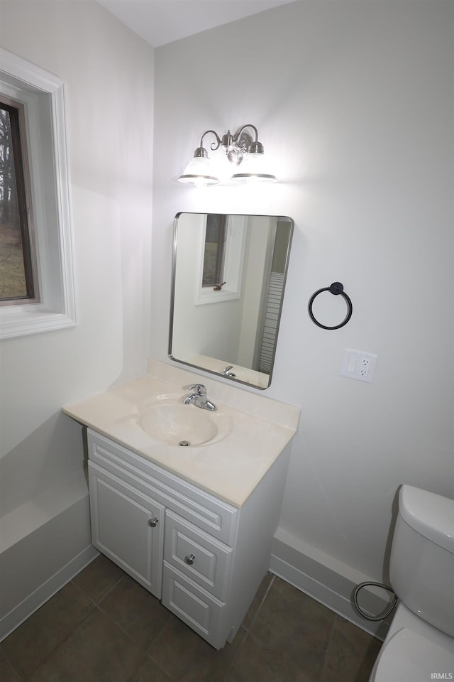 bathroom featuring tile patterned floors, vanity, and toilet