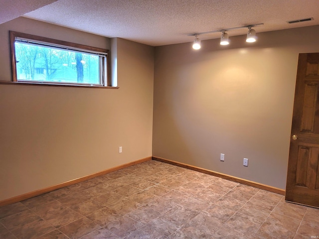 basement featuring a textured ceiling