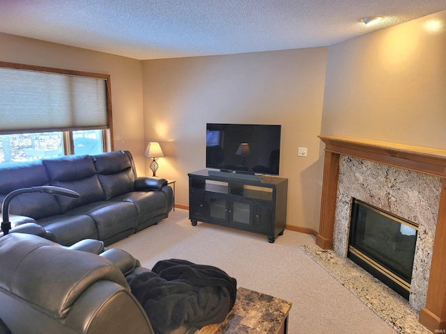 carpeted living room with a fireplace and a textured ceiling