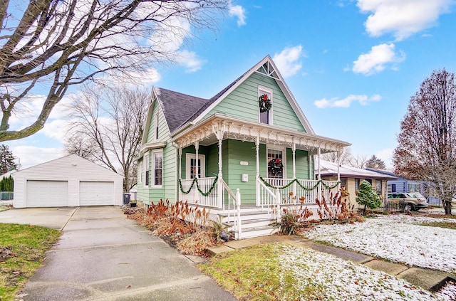 victorian-style house with a porch, a garage, and an outdoor structure