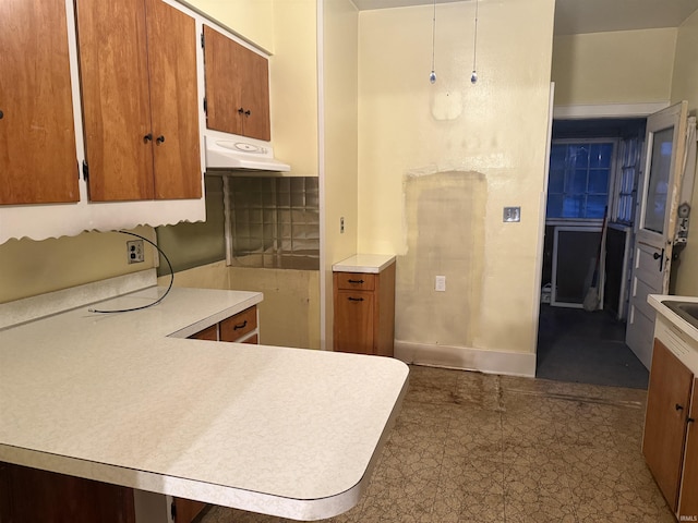 kitchen with hanging light fixtures and kitchen peninsula