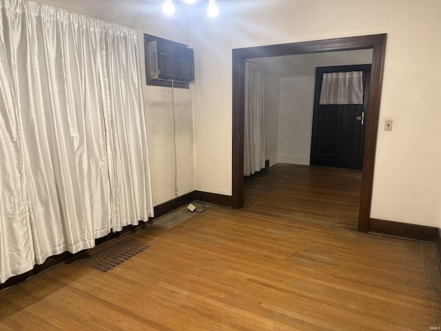 hall featuring hardwood / wood-style flooring and a wall unit AC