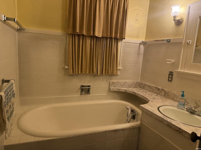 bathroom featuring vanity and tiled bath