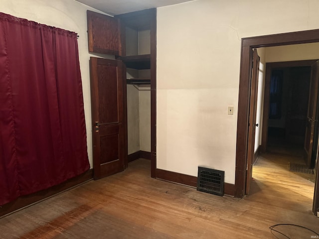 unfurnished bedroom with wood-type flooring