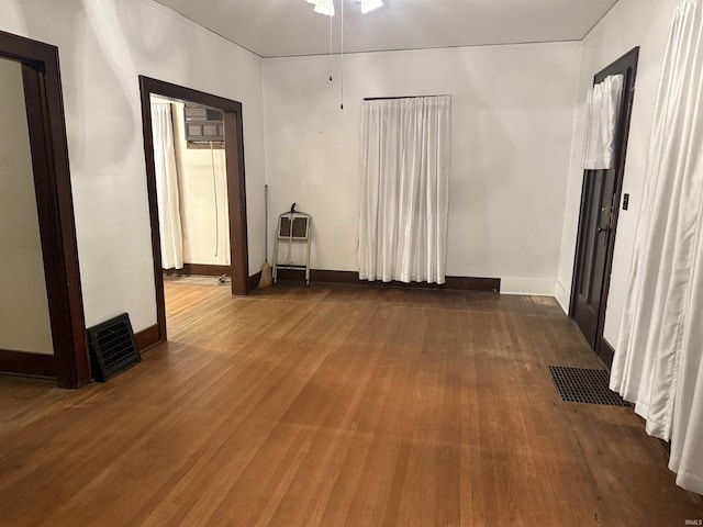 empty room with dark hardwood / wood-style flooring