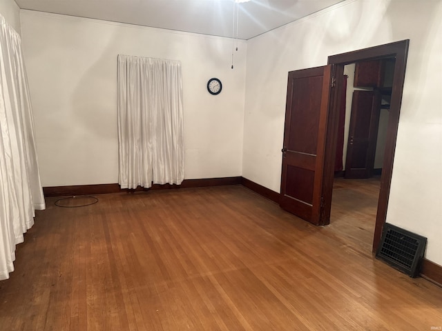 spare room with hardwood / wood-style flooring