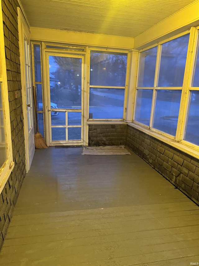 unfurnished sunroom with wood ceiling