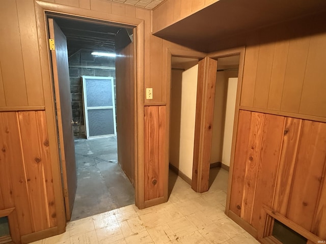 hallway with wood walls