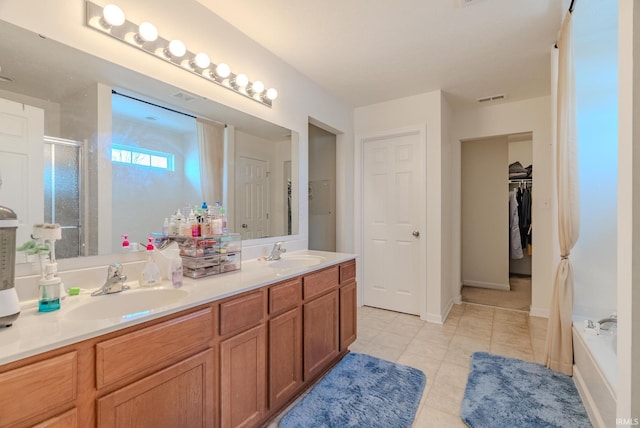 bathroom featuring tile patterned floors, vanity, and separate shower and tub