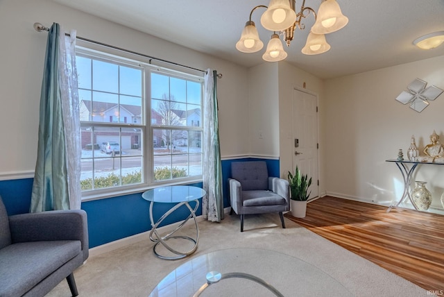 living area featuring wood-type flooring and a chandelier