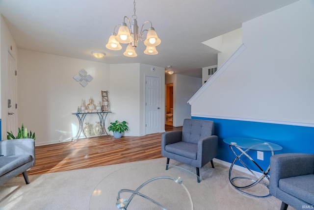 living area featuring a chandelier and hardwood / wood-style floors