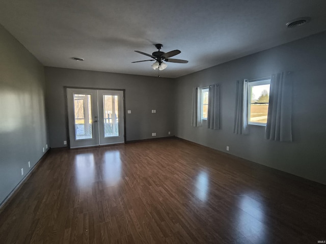 spare room with dark hardwood / wood-style flooring, french doors, and ceiling fan