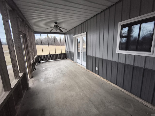 unfurnished sunroom with ceiling fan