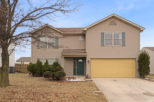 view of front property featuring a garage and central AC unit