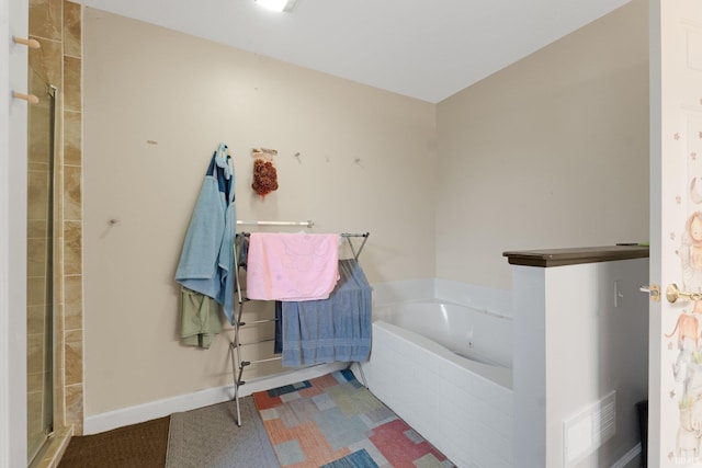 bathroom featuring separate shower and tub