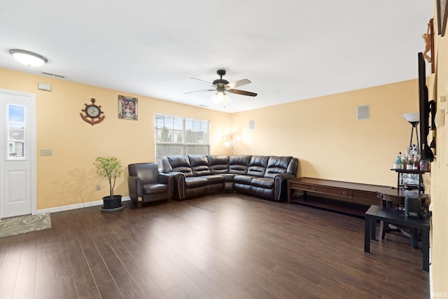 living room featuring ceiling fan and dark hardwood / wood-style floors