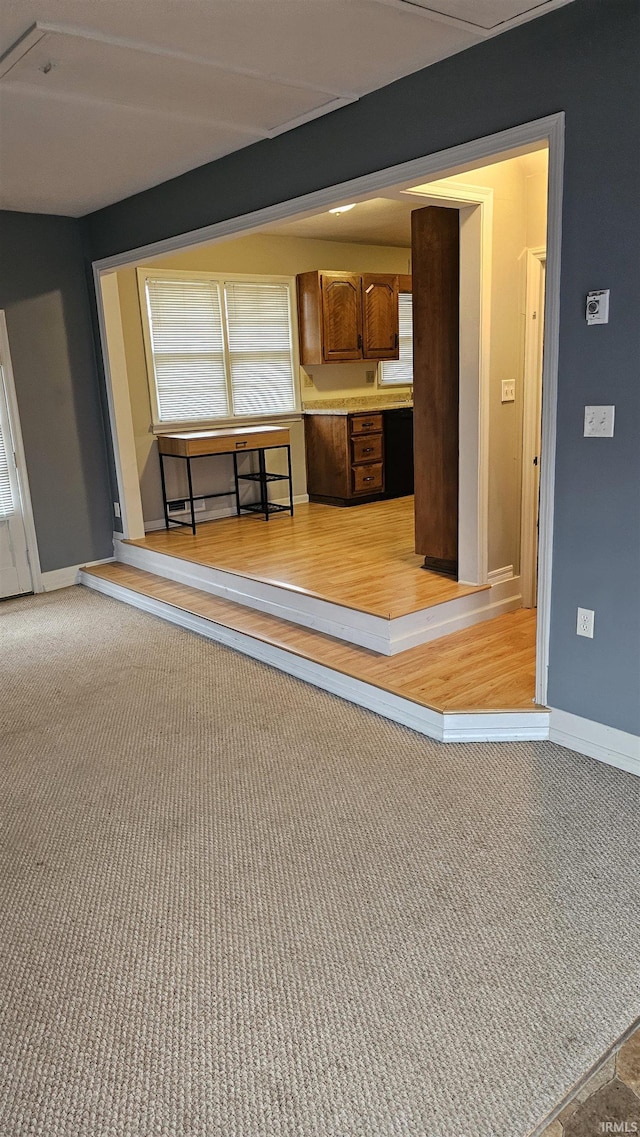 unfurnished living room featuring light colored carpet