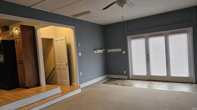 carpeted spare room featuring ceiling fan