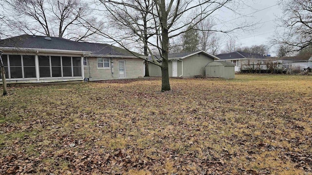 view of yard with a shed and a sunroom