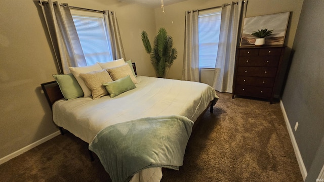 bedroom featuring dark colored carpet