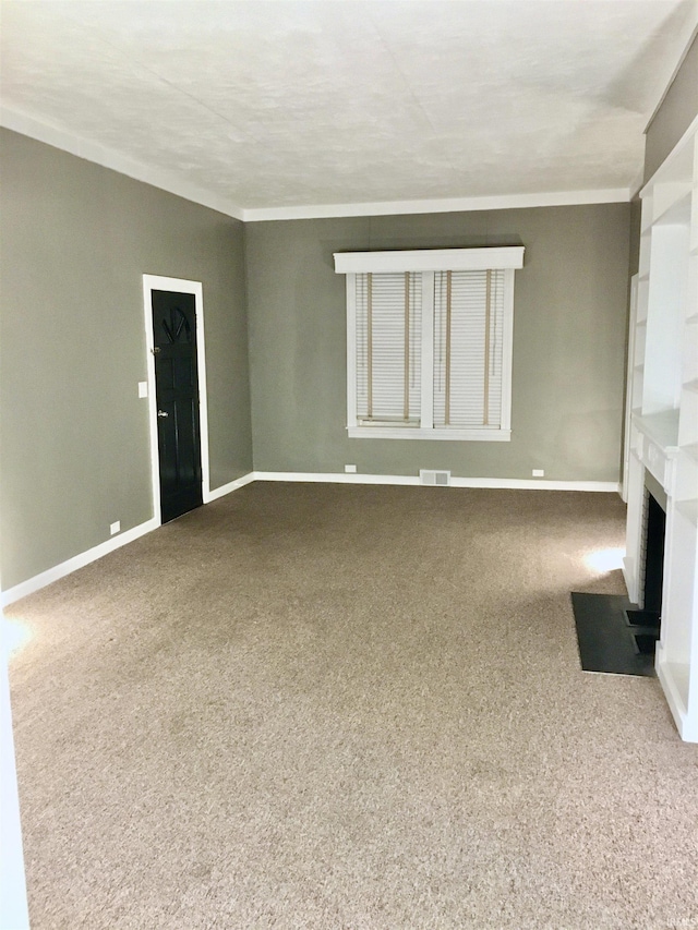 unfurnished living room with ornamental molding and carpet floors