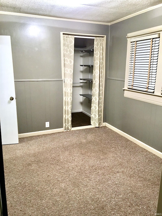 unfurnished bedroom featuring carpet floors, ornamental molding, a closet, and a textured ceiling