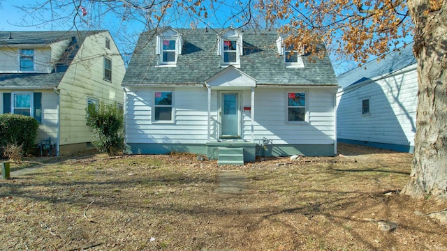 cape cod home with a front lawn