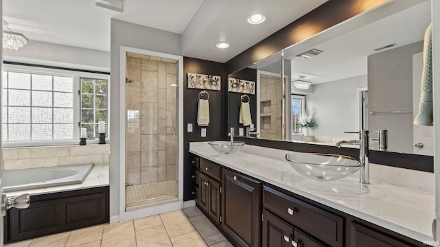 bathroom with vanity, tile patterned flooring, and plus walk in shower