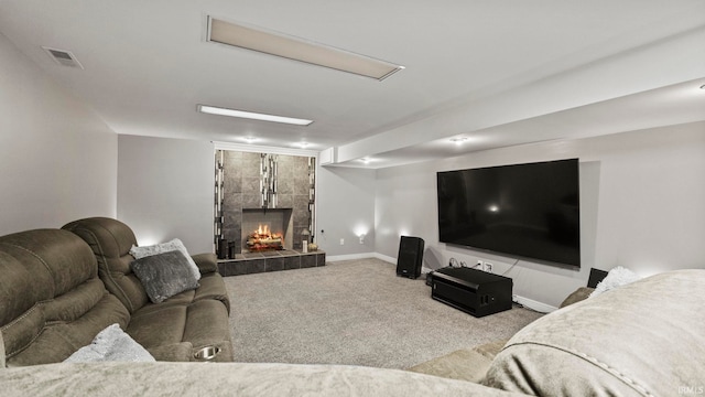 carpeted living room featuring a tile fireplace