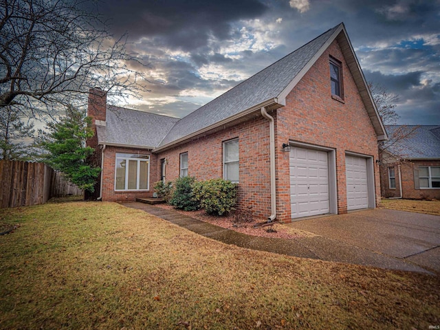 property exterior at dusk featuring a yard and a garage