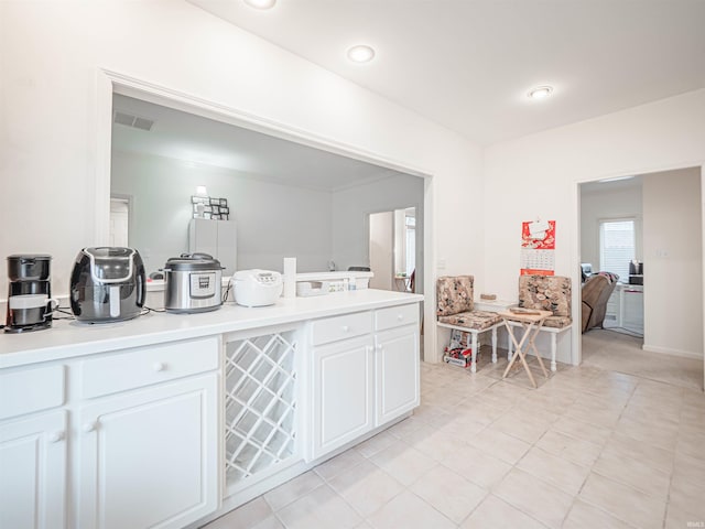 kitchen featuring white cabinetry and light tile patterned floors