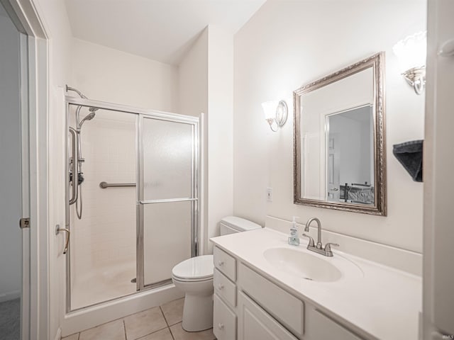 bathroom featuring vanity, toilet, tile patterned floors, and walk in shower