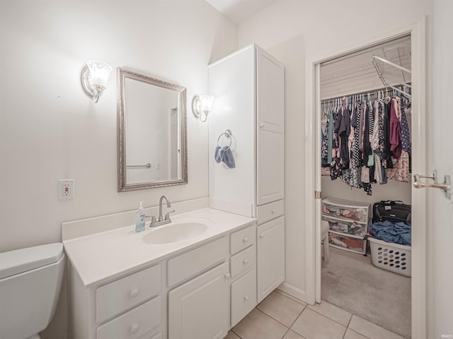 bathroom featuring vanity, tile patterned floors, and toilet